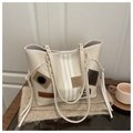 Beige contrast tote bag with patches and long shoulder straps on a cozy wooden desk - White