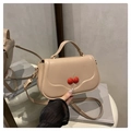 Beige faux leather crossbody bag featuring 3D red cherry charms and top handle strap - Khaki