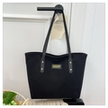 Detail of black corduroy tote bag with fashion label and leather shoulder straps - Black