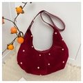 Detail of burgundy suede crescent bag with gold studs and smooth leather strap - Red