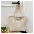 Detail of off-white corduroy tote bag showing ribbed texture and golden hardware - White