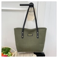 Detail of olive green corduroy tote bag with black leather handles and gold rivet accents - Green
