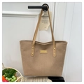 Close-up of light brown corduroy tote bag with leather handles and gold rivets details - Khaki
