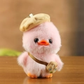 Pink plush duck keychain with khaki beret and palette bag accessory on wooden table - 13cm / Pink