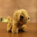Brown curly teddy dog plush keychain accessory sitting on dark wood surface - Brown