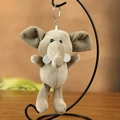 Cute grey plush elephant keychain with long trunk and metal ring hanging on a stand - Elephant