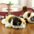 Close-up of tricolor plush cat toy with gold-rimmed eyes on a natural wooden table - Length 18cm / Three-Color Cat