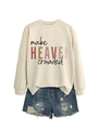 Flat lay of cream 'make HEAVEN crowded' sweatshirt paired with distressed denim shorts - Sand (Black Print)