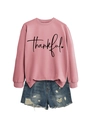 Close-up of pink crewneck sweatshirt with thankful print and distressed denim shorts - Rose Gold (Black Font)