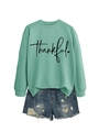 Detail of mint green sweatshirt with thankful print and distressed denim shorts - Light Green (Black Text)
