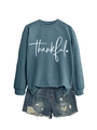 Detailed view of the 'thankful' script print on teal crewneck sweatshirt with denim shorts - Blue (White Font)