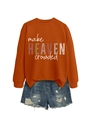 Flat lay of burnt orange sweatshirt with make HEAVEN crowded text and denim shorts - Burnt Orange (White Print)