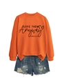 Detail of orange crewneck sweatshirt with Love Them Anyway print and denim shorts - Orange Sweatshirt (Black Font)