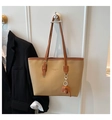 Detail of khaki tote bag with brown trim and orange elephant charm accessory - Khaki