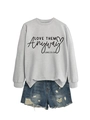 Detail of grey crewneck sweatshirt with Love Them Anyway print and ripped denim shorts - Grey Sweatshirt (Black Font)