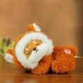 Cute brown plush panda doll in a white hoodie lying on a wooden table for kids - Red Fox