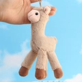 Portachiavi in peluche di alpaca beige con catena in metallo e sfondo di cielo azzurro - Marrone