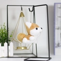 Close-up of cute husky plush pendant with a metal bead chain on a modern display stand - Brown / 10cm