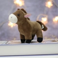 Brown plush horse keychain with long mane standing on a book in cozy warm lighting - Dark Brown / 14.0cm