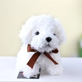 Close-up of white plush teddy dog toy featuring soft fluffy fur and a brown ribbon bow - 12cm / White