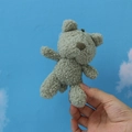 Sage green teddy bear plush keychain in hand showing soft curly fur texture and size - 12cm / Army Green
