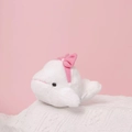 Close-up of white plush beluga whale keychain with pink bow on knitted texture - 12cm / Dolphin