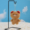 Detail view of light brown sherpa bear keychain with soft texture and silver metal chain - Bear