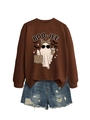 Close-up of the BOO-JEE ghost print on a brown crewneck sweatshirt with distressed denim shorts - Coffee