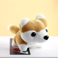 Close-up of a cute plush husky keychain with soft brown and white fur on a desk - Tan