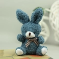 Close-up of blue plush bunny toy with long ears and brown checkered bowtie detail - Dark Green / 10cm