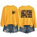Detail view of yellow crewneck sweatshirt with 'I HAVE REALLY COOL TATTOOS' slogan print - S / Tops / Yellow (Black Print)