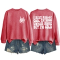 Flat lay of red crewneck sweatshirt with 'I HAVE REALLY COOL TATTOOS' text and ripped denim - S / Tops / Red (White Print)