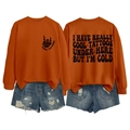 Close-up of orange sweatshirt with Cool Tattoos print on front and back designs - S / Tops / Burnt Orange (Black Print)