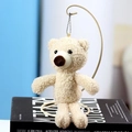 Cream teddy bear plush charm with soft faux fur and golden chain on a display stand - Height approx 20cm / Off White