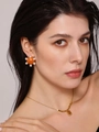Close-up of bright orange enamel ball earring with white pearls and gold chain necklace - Orange