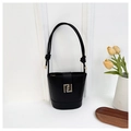 Close-up of black leather bucket bag featuring a gold geometric metal magnetic buckle - Black