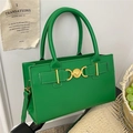 Vibrant green faux leather handbag with gold heart buckle and adjustable shoulder strap - Green