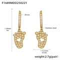Detail view of gold baby feet earrings with inlaid zircons and heart cutout on stainless steel - Baby Feet Style (F1689)