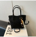 Elegant black matte leather bucket bag with retro wooden bead charm on a display box - Black with Pendant