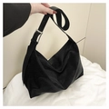 Detail of black PU leather shoulder bag featuring wide strap and silver metal buckle - Black