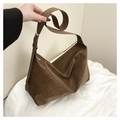 Macro detail of the matte suede texture and adjustable silver buckle on the brown hobo bag - Brown