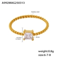 Macro detail of twisted gold ring band featuring a square zircon and size measurements - US 6 / Gold