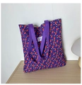 Detailed macro of floral pattern fabric with TIANYC brand label on purple tote bag - Purple