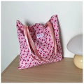 Detailed view of pink floral canvas tote bag on wooden table with a mushroom lamp - Pink