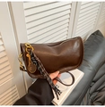 Detail of vintage brown leather bag featuring golden tennis racket pendant and metal chain - Coffee with Pendant