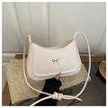 Creamy crescent shoulder bag with a silver bow ornament and knotted leather strap - White