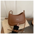 Caramel brown leather shoulder bag with a silver metallic bow and crescent shape design - Brown