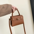 Caramel brown pebbled leather handbag with gold metal clasp and top handle design - Brown