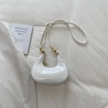 Detail of white glossy leather crescent bag with golden logo and metallic zipper - White