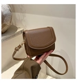 Close-up of brown lychee-patterned leather crossbody bag with golden buckle hardware - No Pendant / Brown